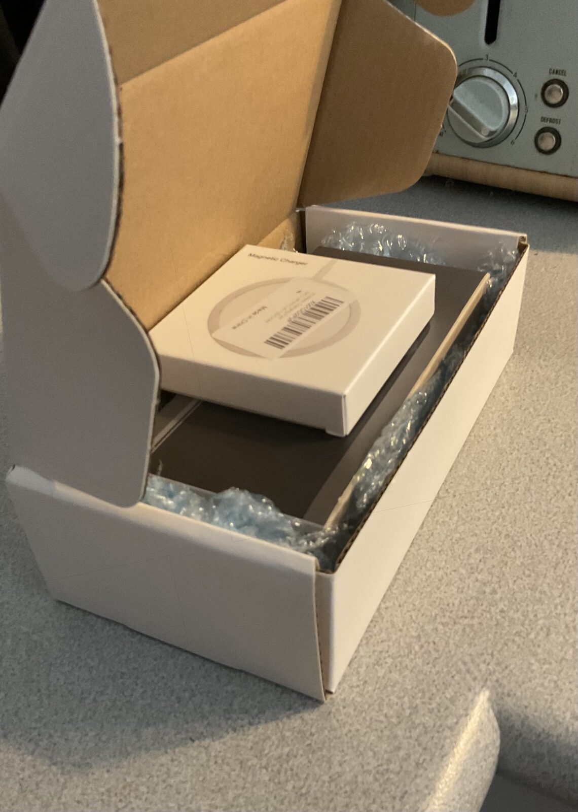 Sealed shipping box with charger packed