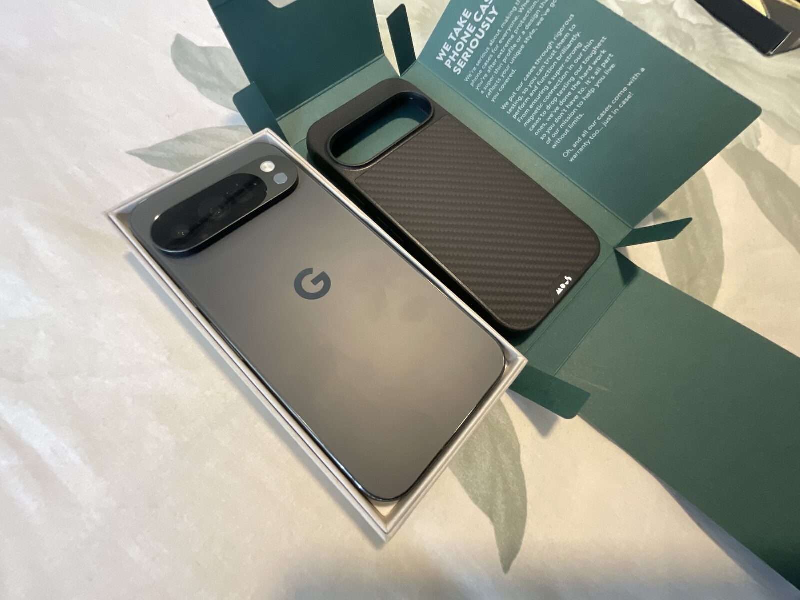 Pixel in its case beside the charger and setup card