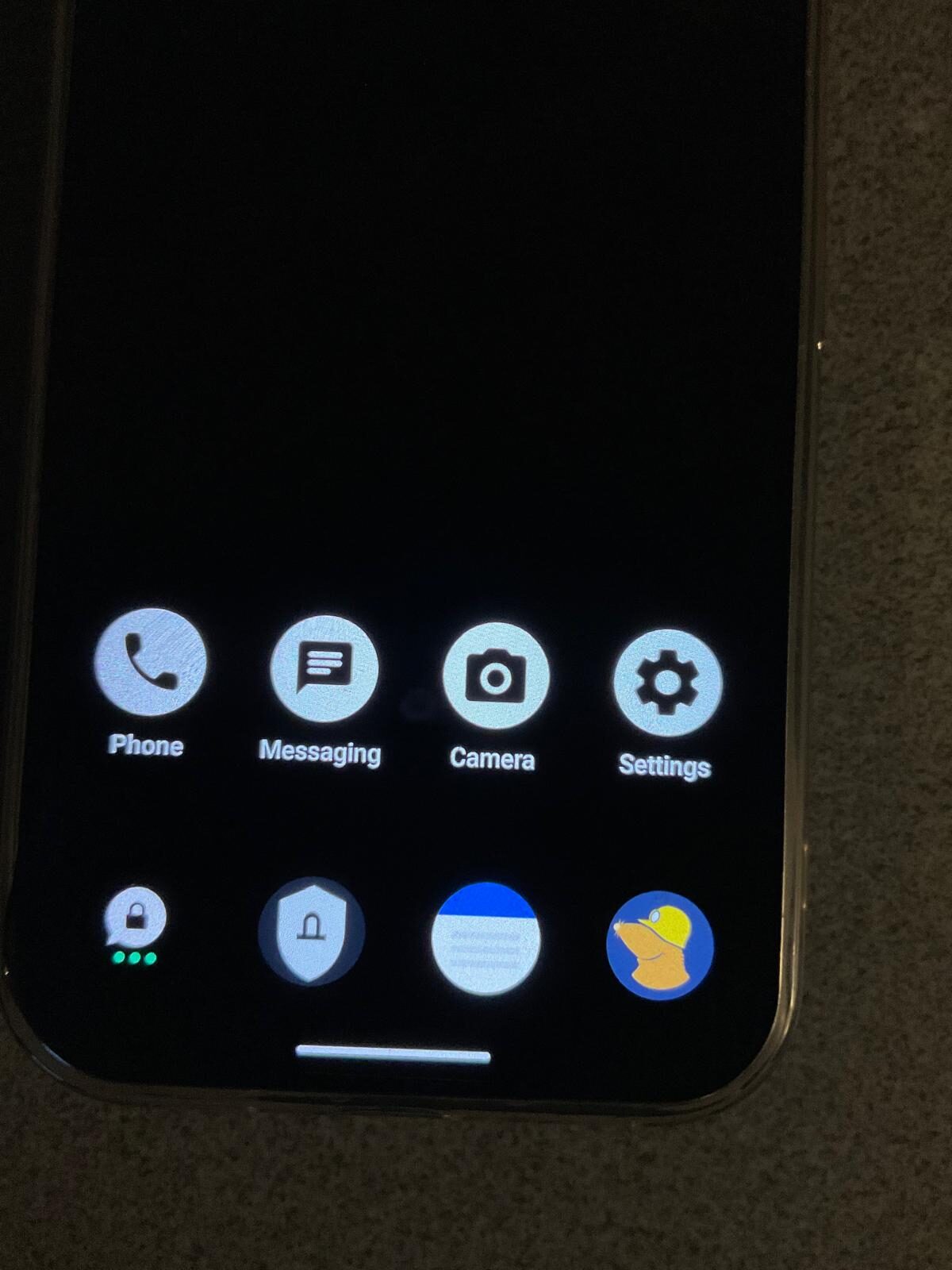 Minimal GrapheneOS home screen: Phone, Messaging, Camera, Settings