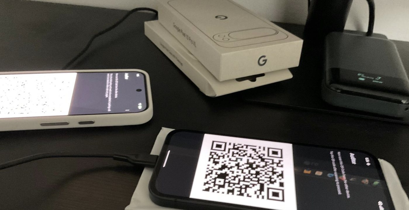 Pixel phones on the configuration bench during a GrapheneOS setup and data-transfer test